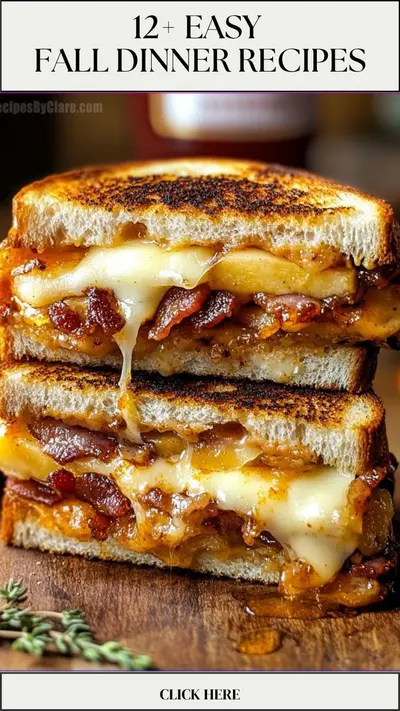 A stacked grilled cheese sandwich with melting cheese, crispy bacon, and apple slices on a wooden board.